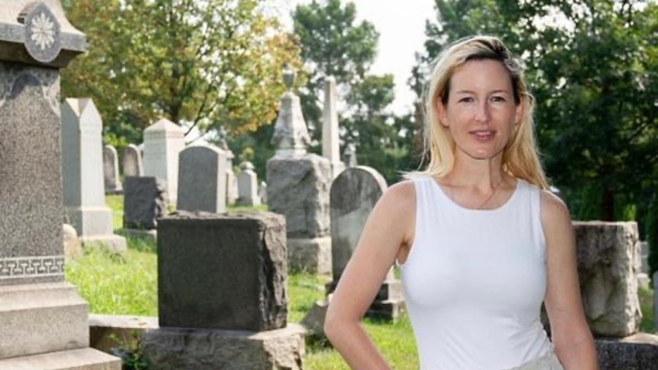 Photo of Rosemary Grant standing in a graveyard smiling